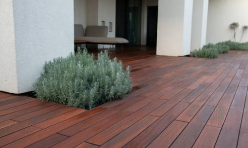 Wooden decks Patio with white concrete columns on hardwood deck lavender scrub pots and furniture